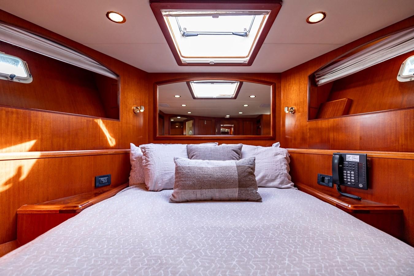 a bed with a white bed spread aboard ANNIE Yacht for Sale