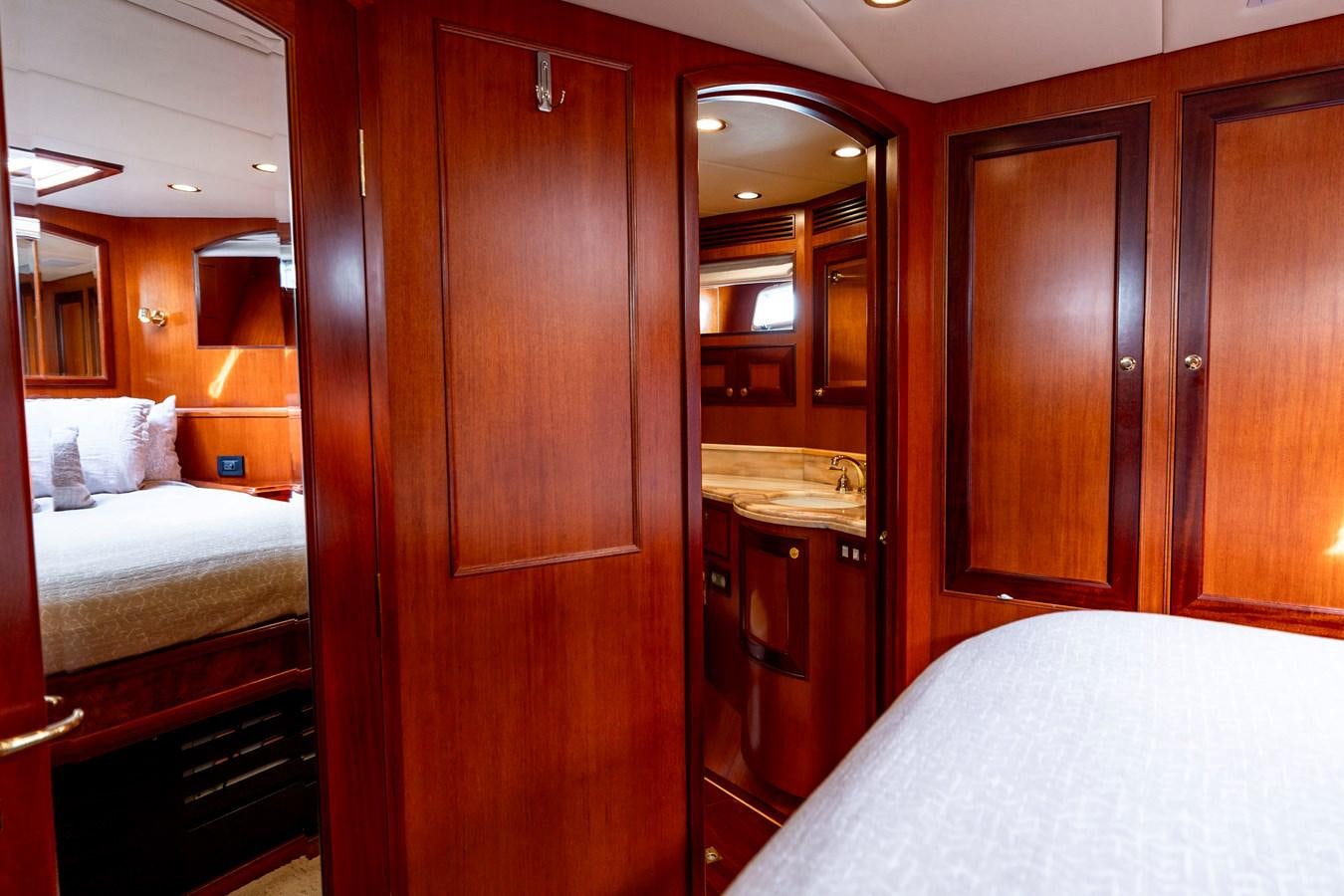 a bedroom with a bed and a closet aboard ANNIE Yacht for Sale