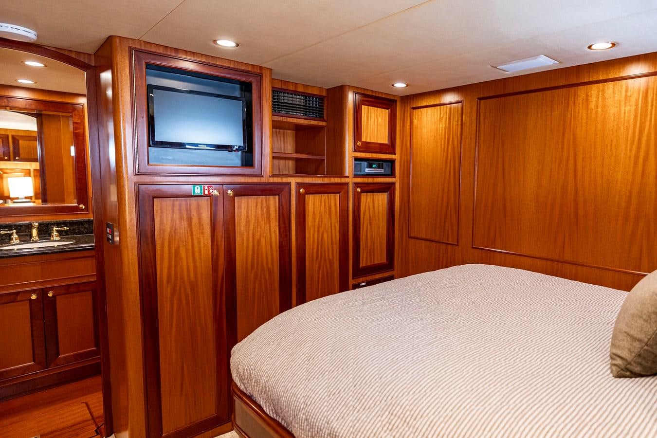a bedroom with a bed and a television aboard ANNIE Yacht for Sale