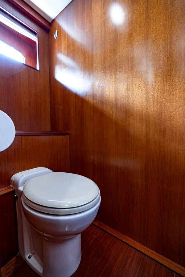 a toilet in a bathroom aboard ANNIE Yacht for Sale