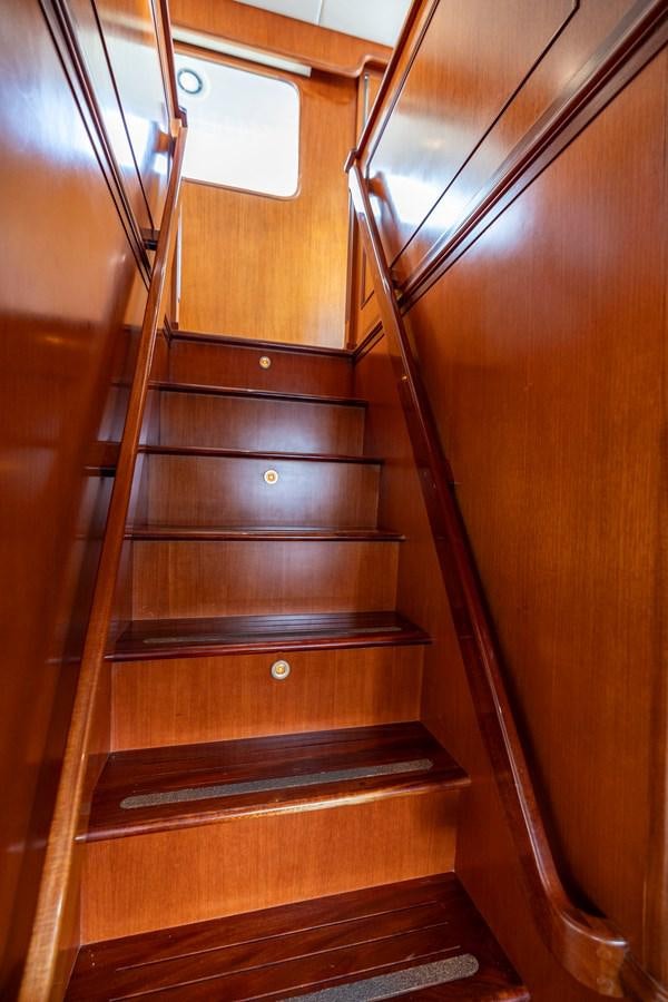 a wooden staircase with a glass door aboard ANNIE Yacht for Sale