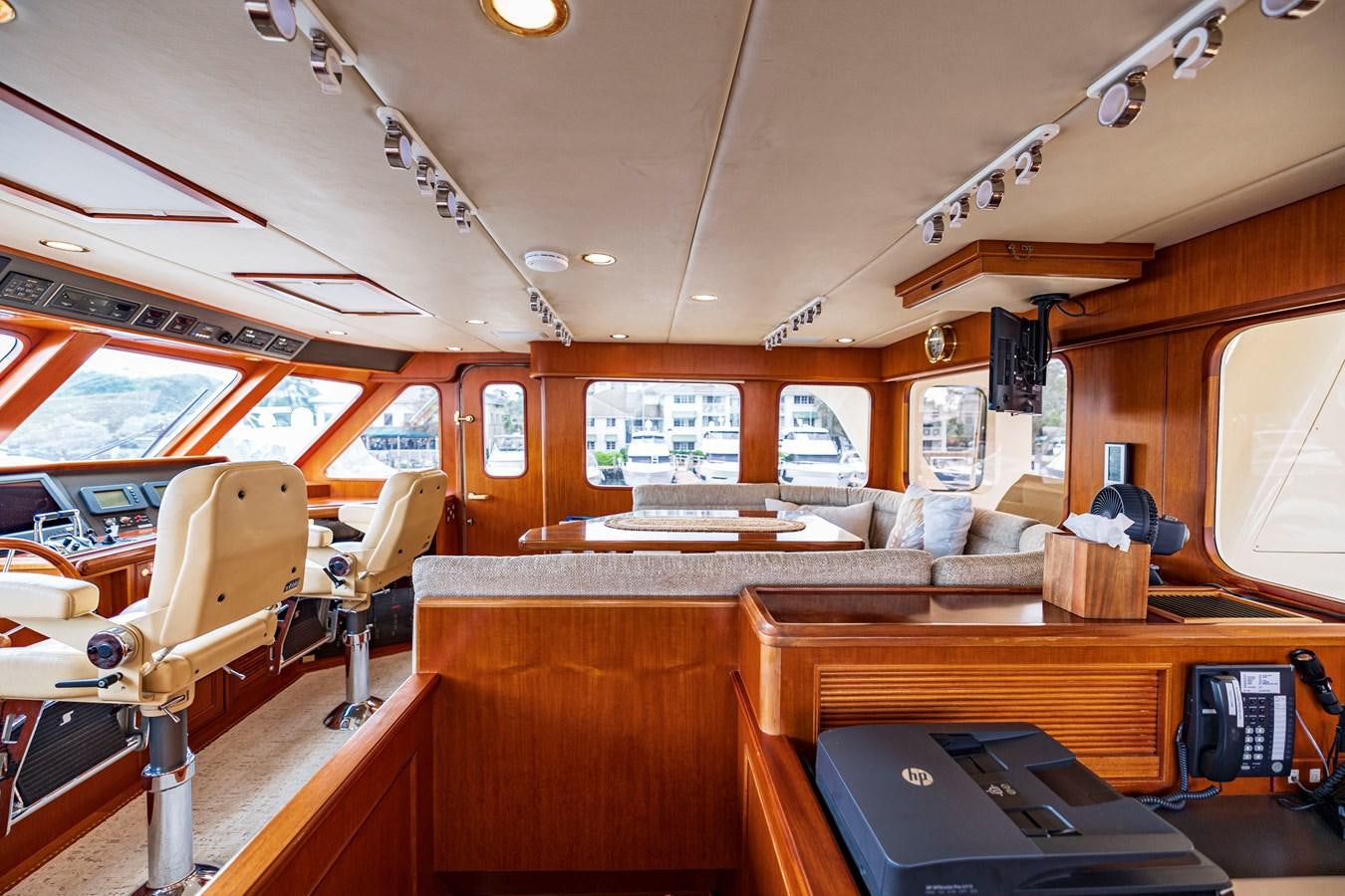 inside of a vehicle with a desk and chairs and a large window aboard ANNIE Yacht for Sale