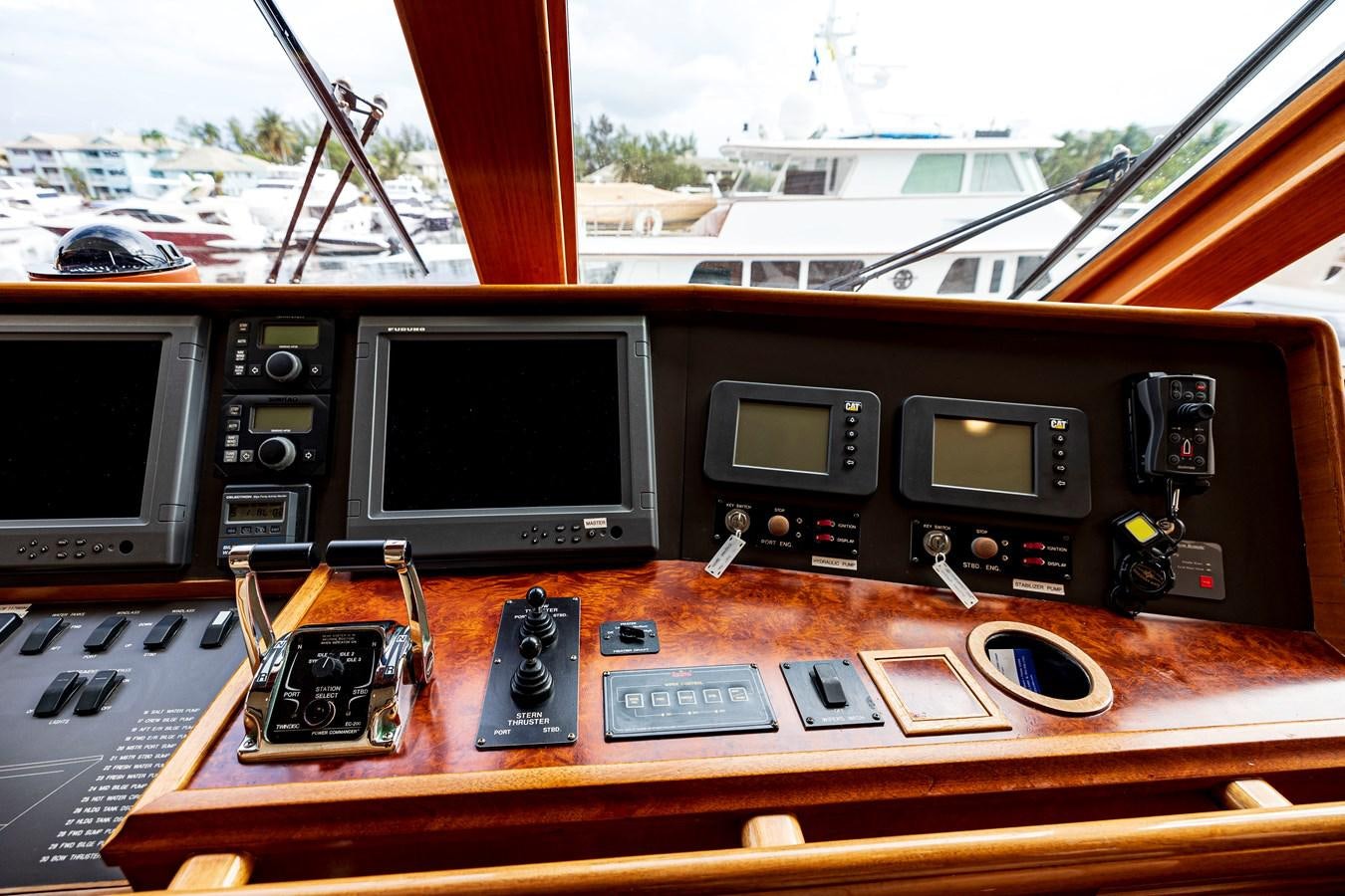 a wooden table with electronic devices aboard ANNIE Yacht for Sale