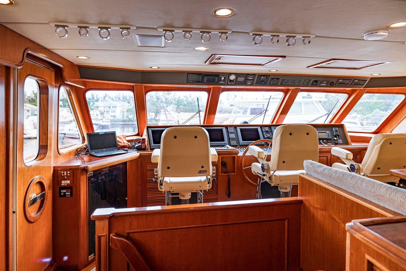inside of a vehicle with a laptop on a desk aboard ANNIE Yacht for Sale
