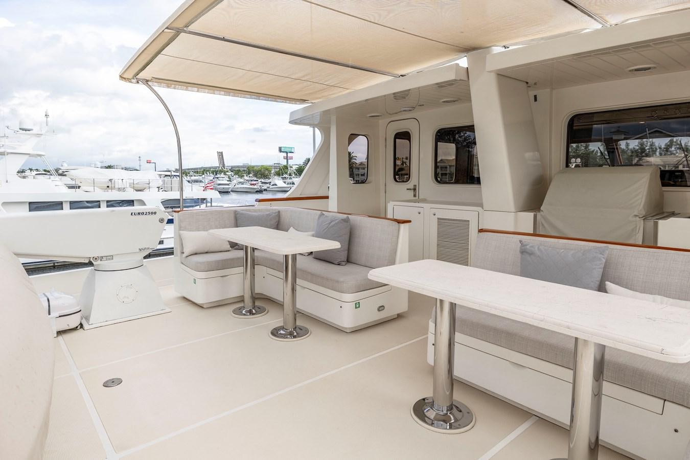 a room with a table and couch aboard ANNIE Yacht for Sale