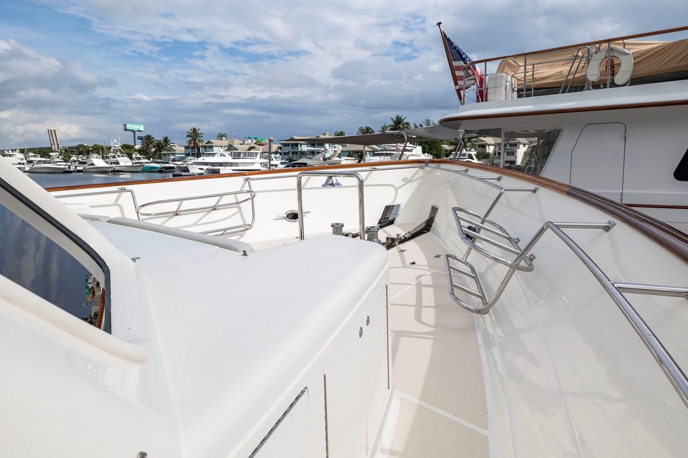 a large white boat with a flag on the deck aboard ANNIE Yacht for Sale