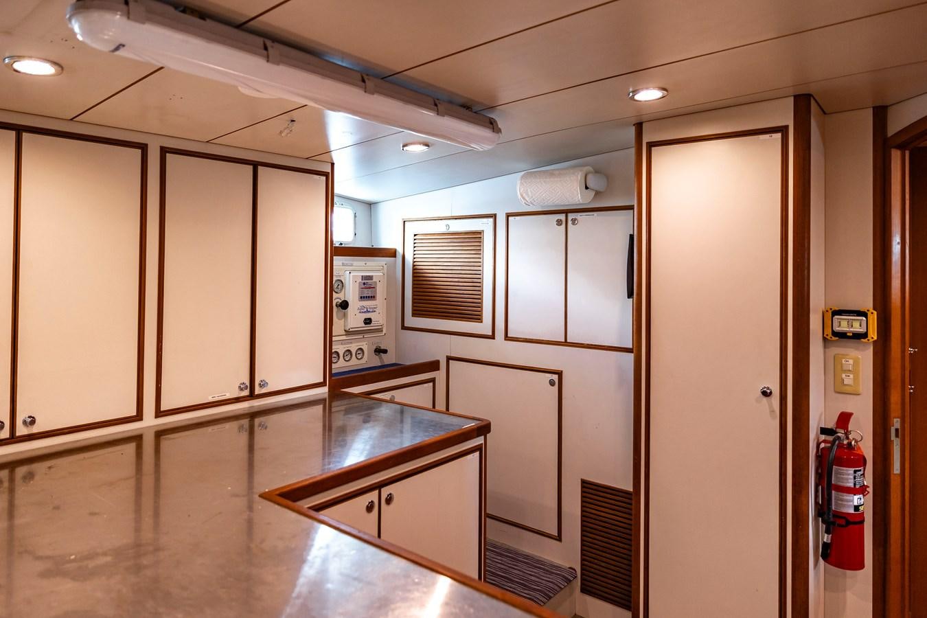 a kitchen with cabinets and appliances aboard ANNIE Yacht for Sale