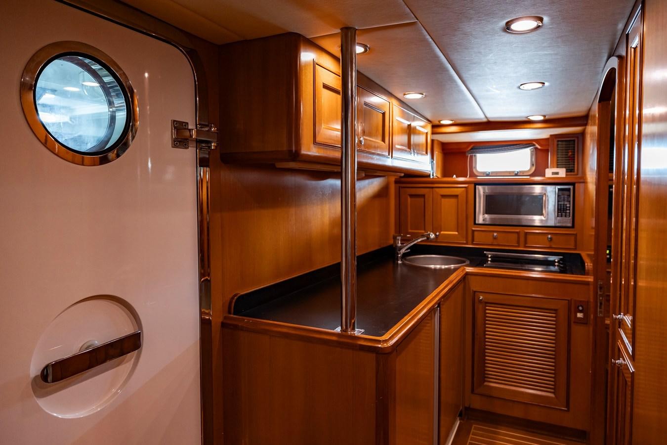 a kitchen with wooden cabinets aboard ANNIE Yacht for Sale