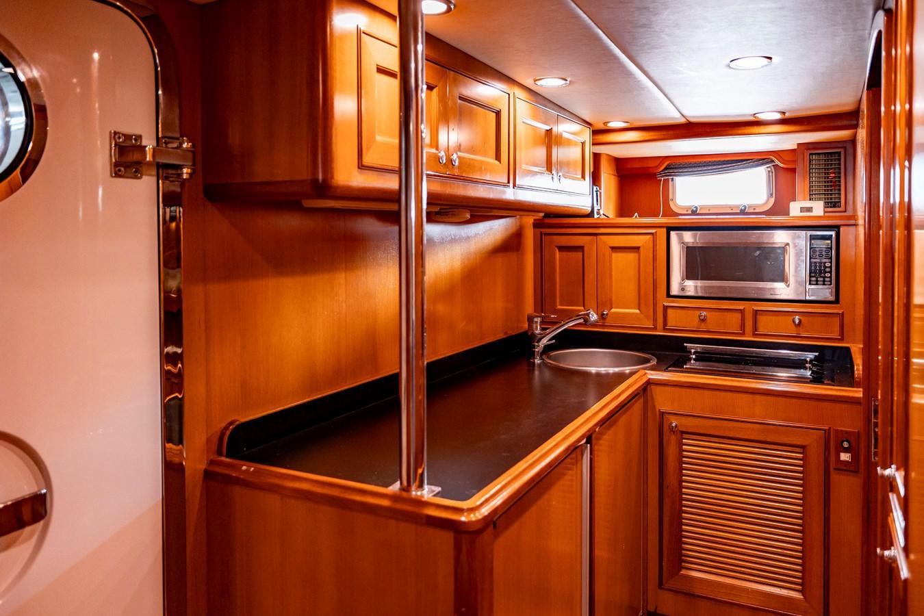 a kitchen with wooden cabinets aboard ANNIE Yacht for Sale