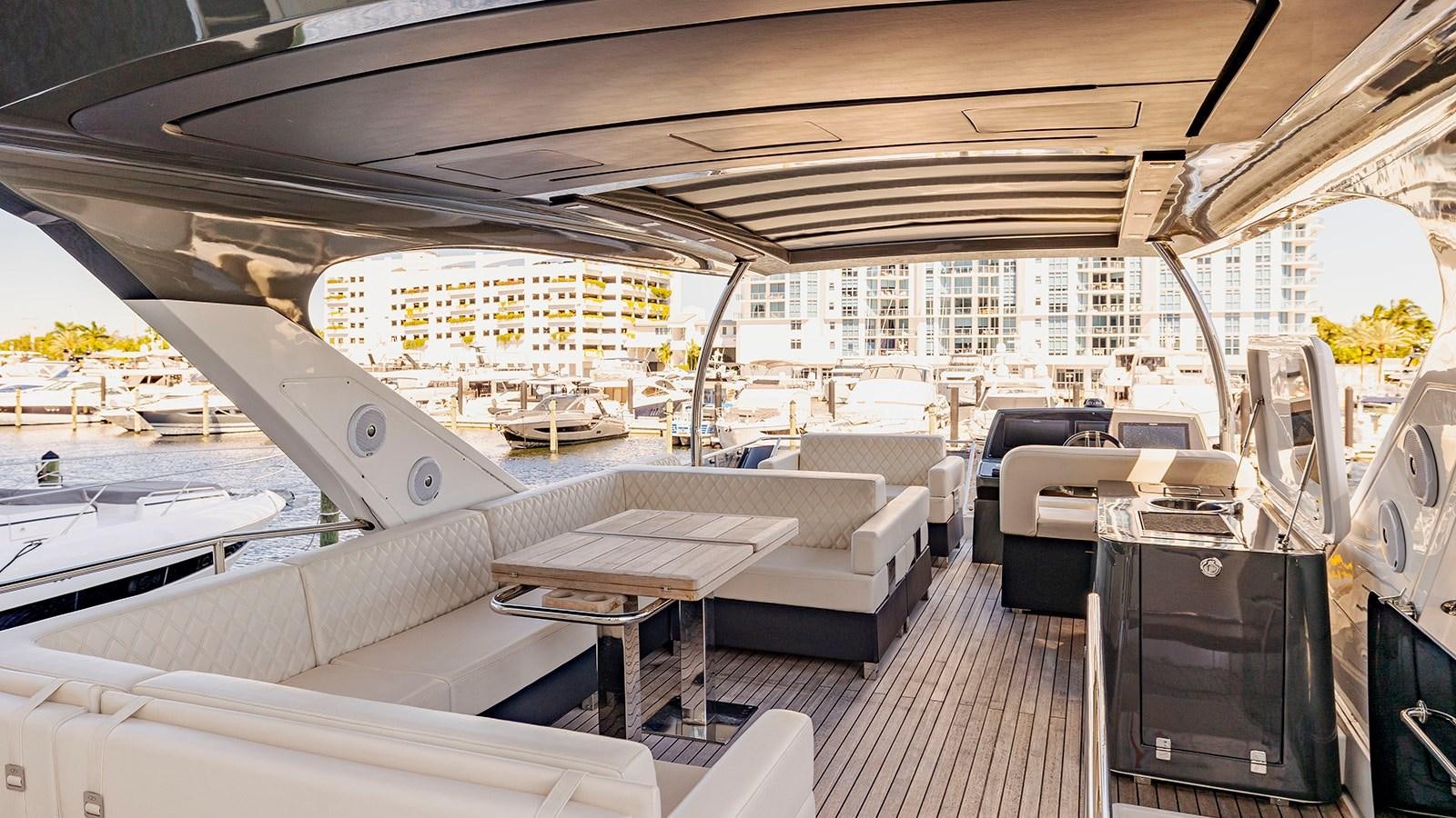 a room with a couch and a table and a television aboard MON TON Yacht for Sale