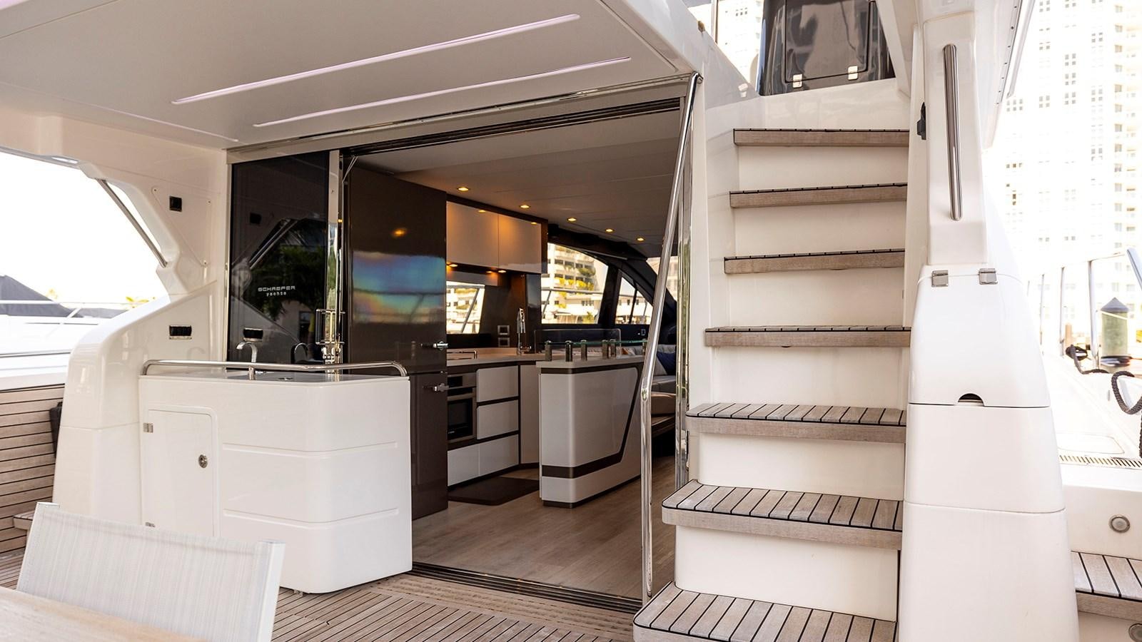 a kitchen with a large white refrigerator aboard MON TON Yacht for Sale