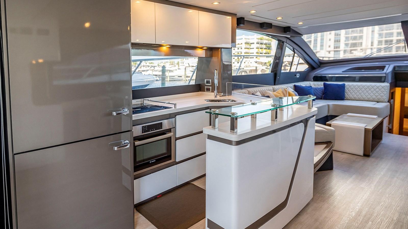 a kitchen with a large glass window aboard MON TON Yacht for Sale