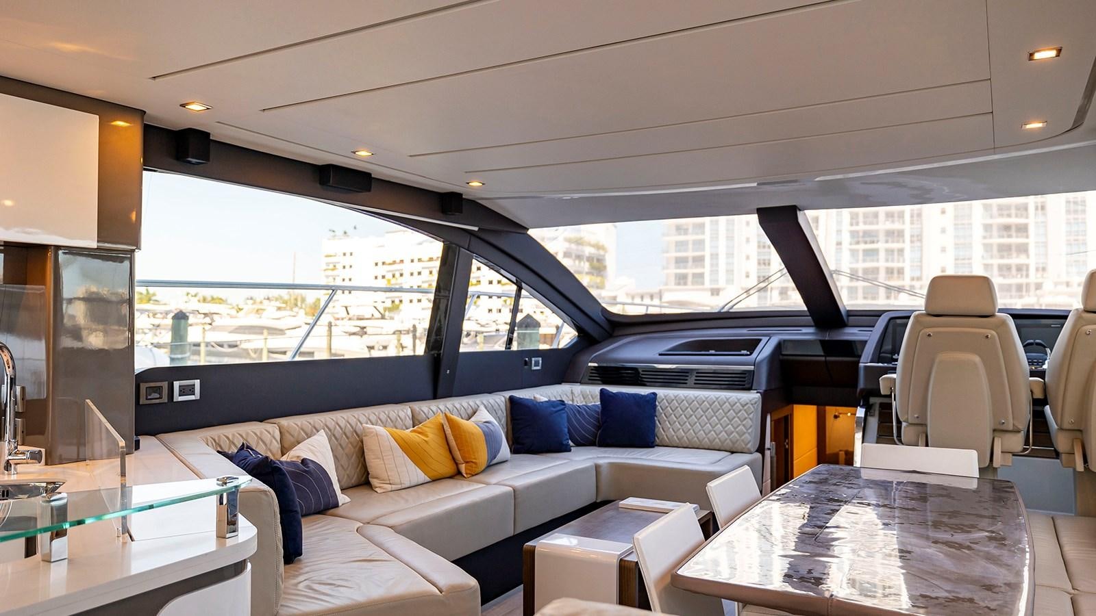 a living room with a couch and a table aboard MON TON Yacht for Sale