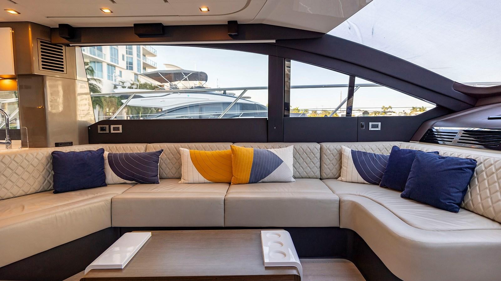 a couch with pillows and a table aboard MON TON Yacht for Sale