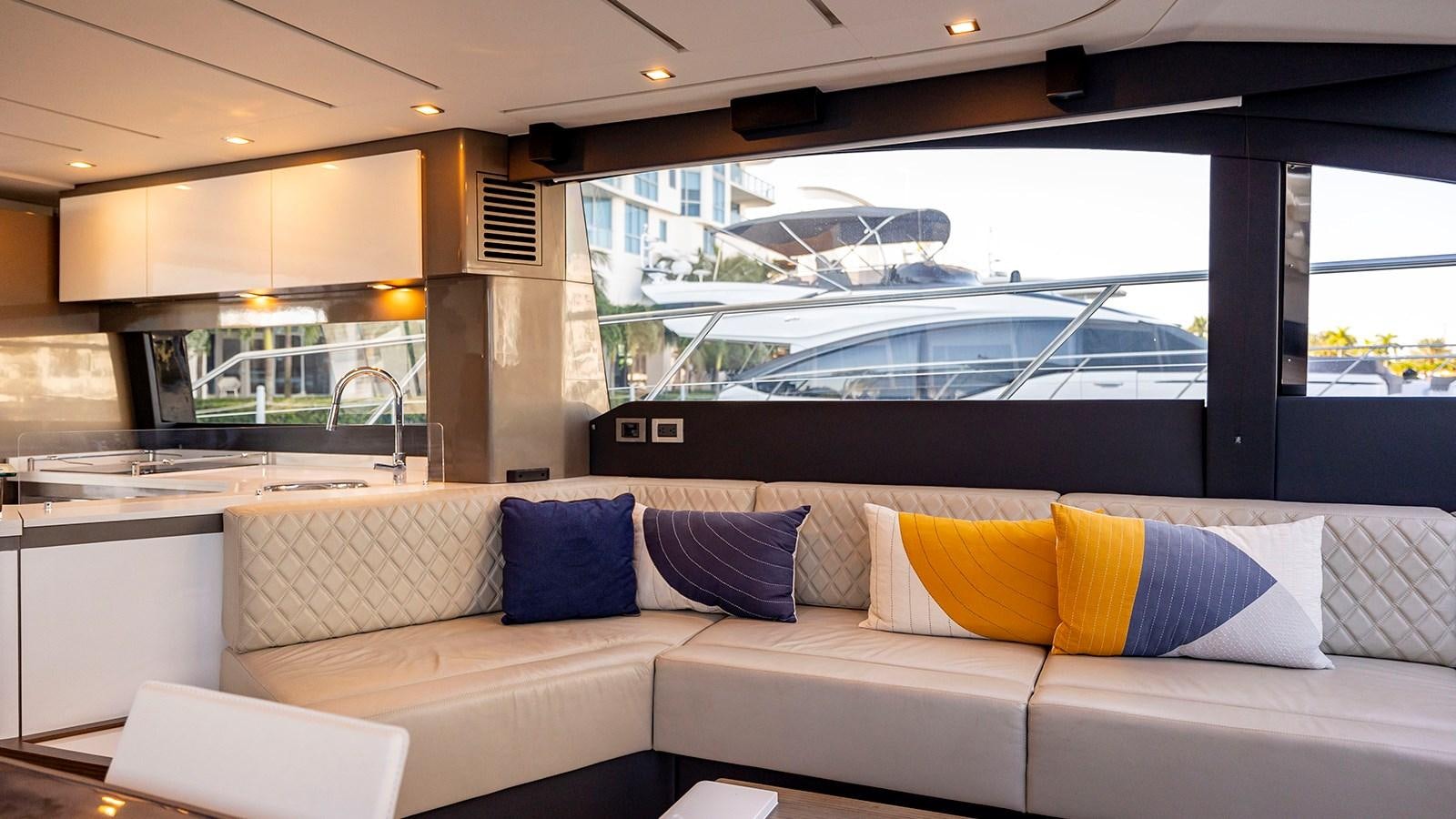 a white couch with pillows aboard MON TON Yacht for Sale