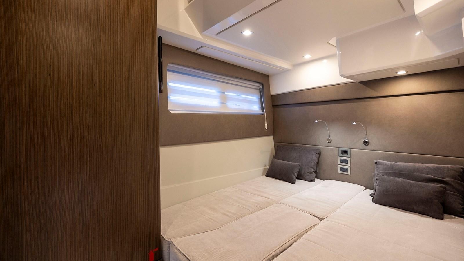 a room with a bed and a couch aboard MON TON Yacht for Sale