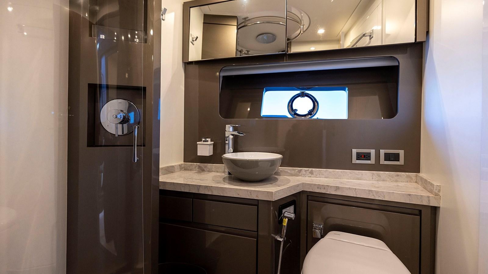 a bathroom with a sink and a toilet aboard MON TON Yacht for Sale