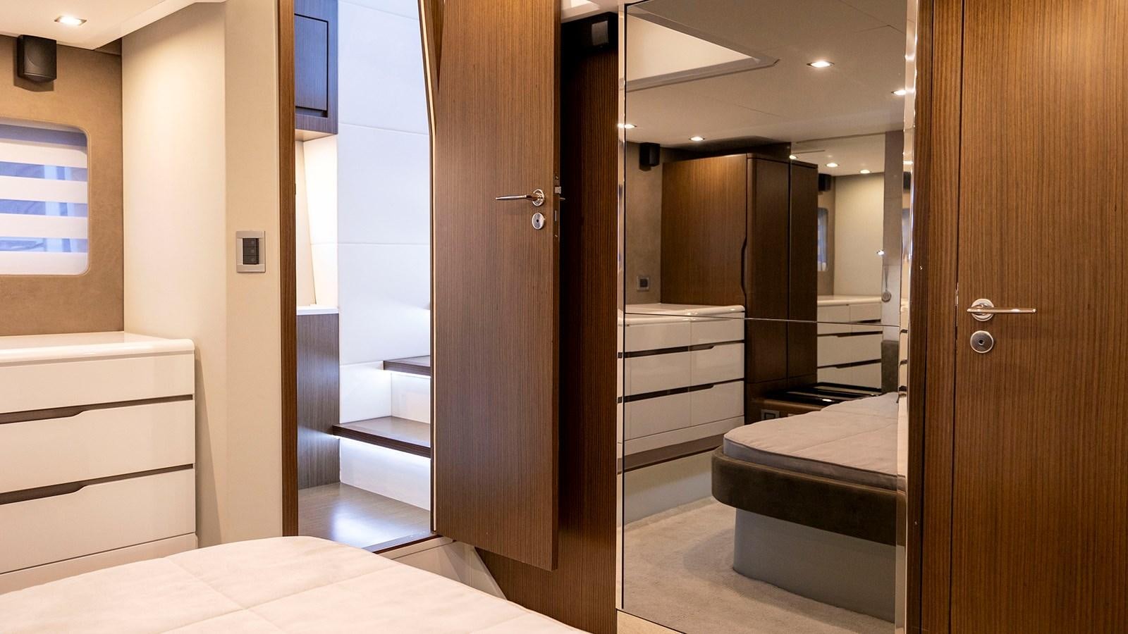 a room with a bed and a door aboard MON TON Yacht for Sale