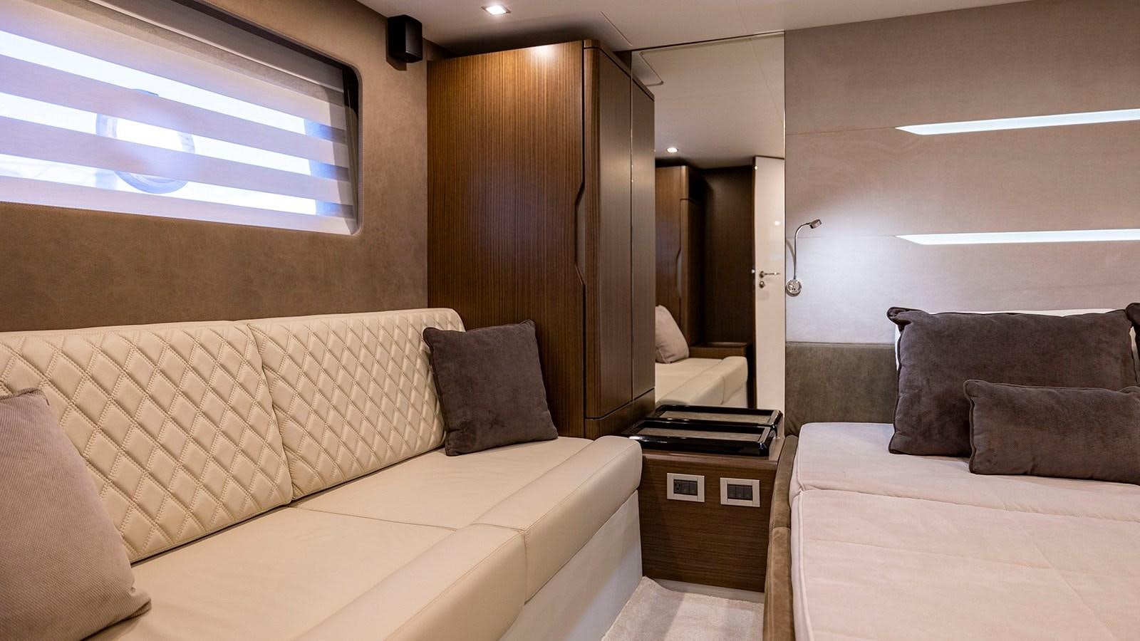 a room with a couch and a television aboard MON TON Yacht for Sale