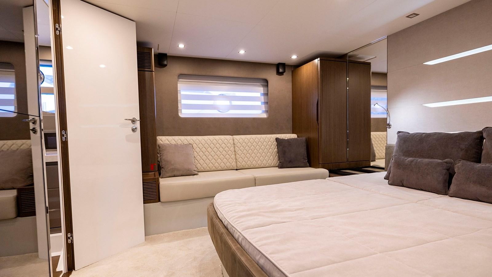 a bedroom with a bed and a couch aboard MON TON Yacht for Sale