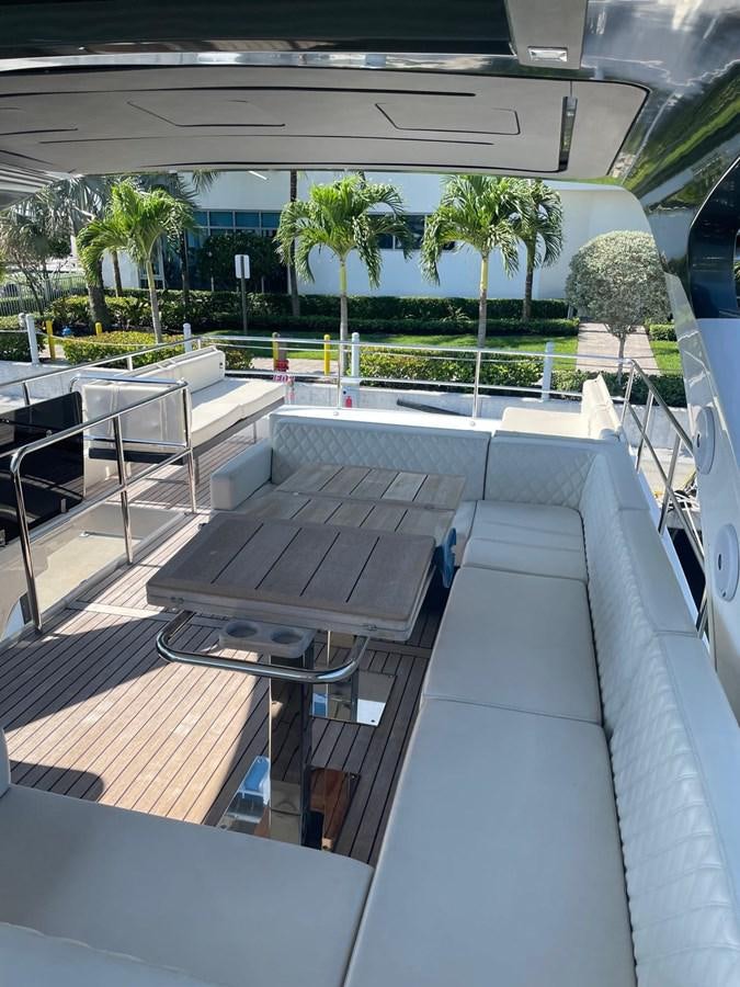 a patio with a table and chairs aboard MON TON Yacht for Sale