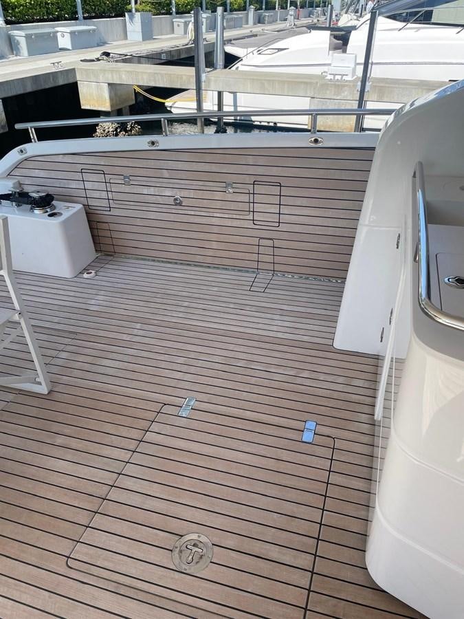 a deck with a deck and a large white boat on it aboard MON TON Yacht for Sale