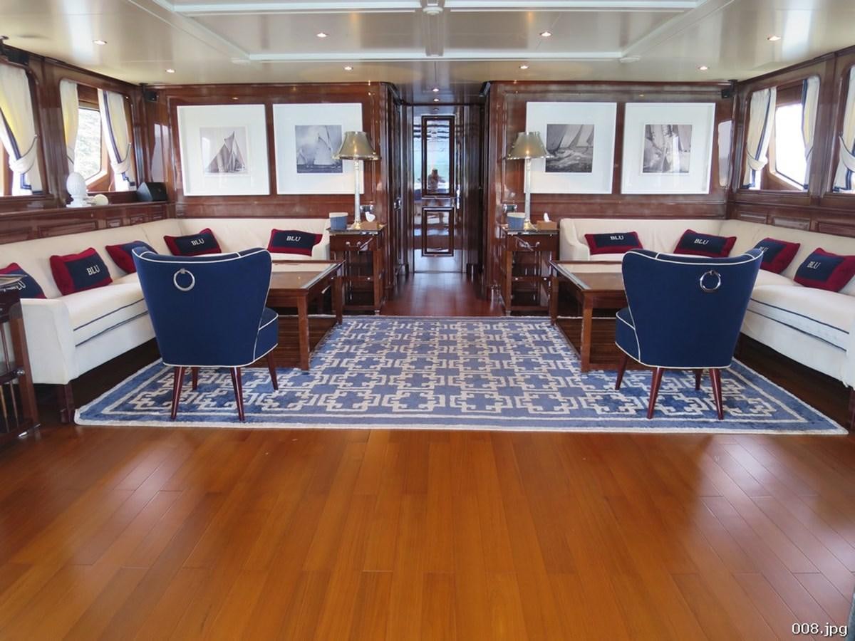 a room with a couch and a table and chairs aboard BLU Yacht for Sale