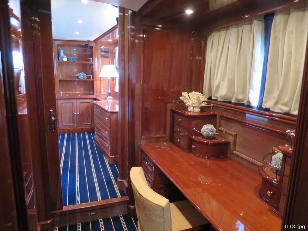 a room with a wood cabinet and a bench and a table aboard BLU Yacht for Sale