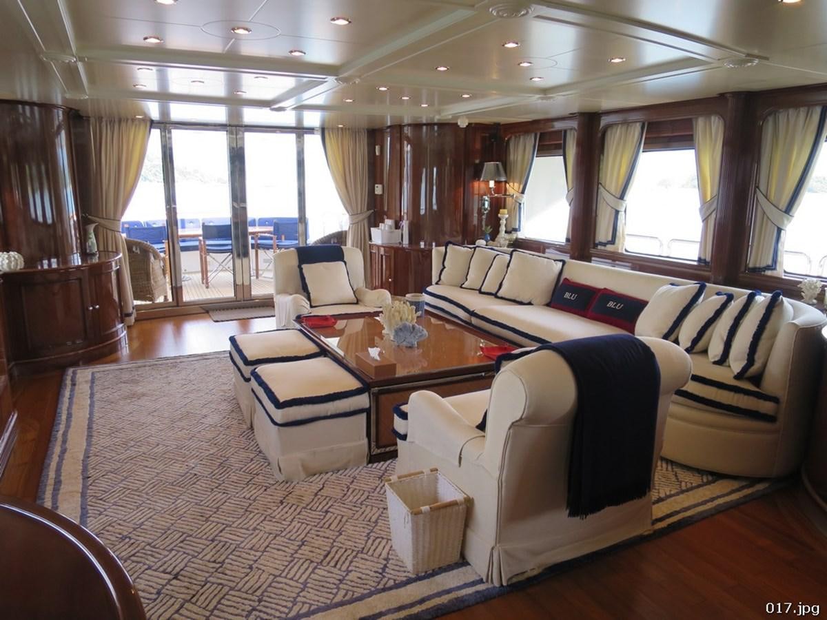 a living room with a couch and a table aboard BLU Yacht for Sale