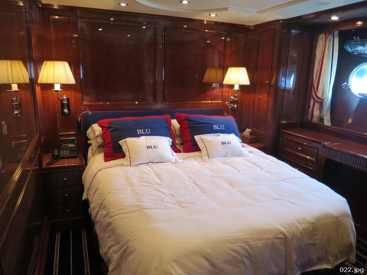 a bed with pillows on it aboard BLU Yacht for Sale