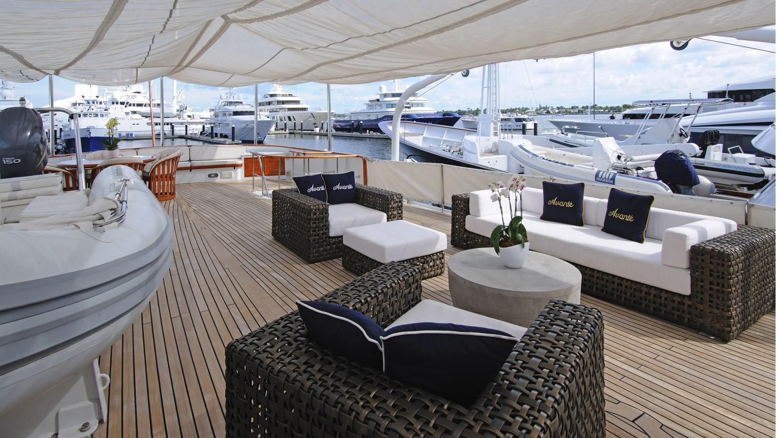 a boat deck with couches and chairs aboard AVANTE V Yacht for Sale