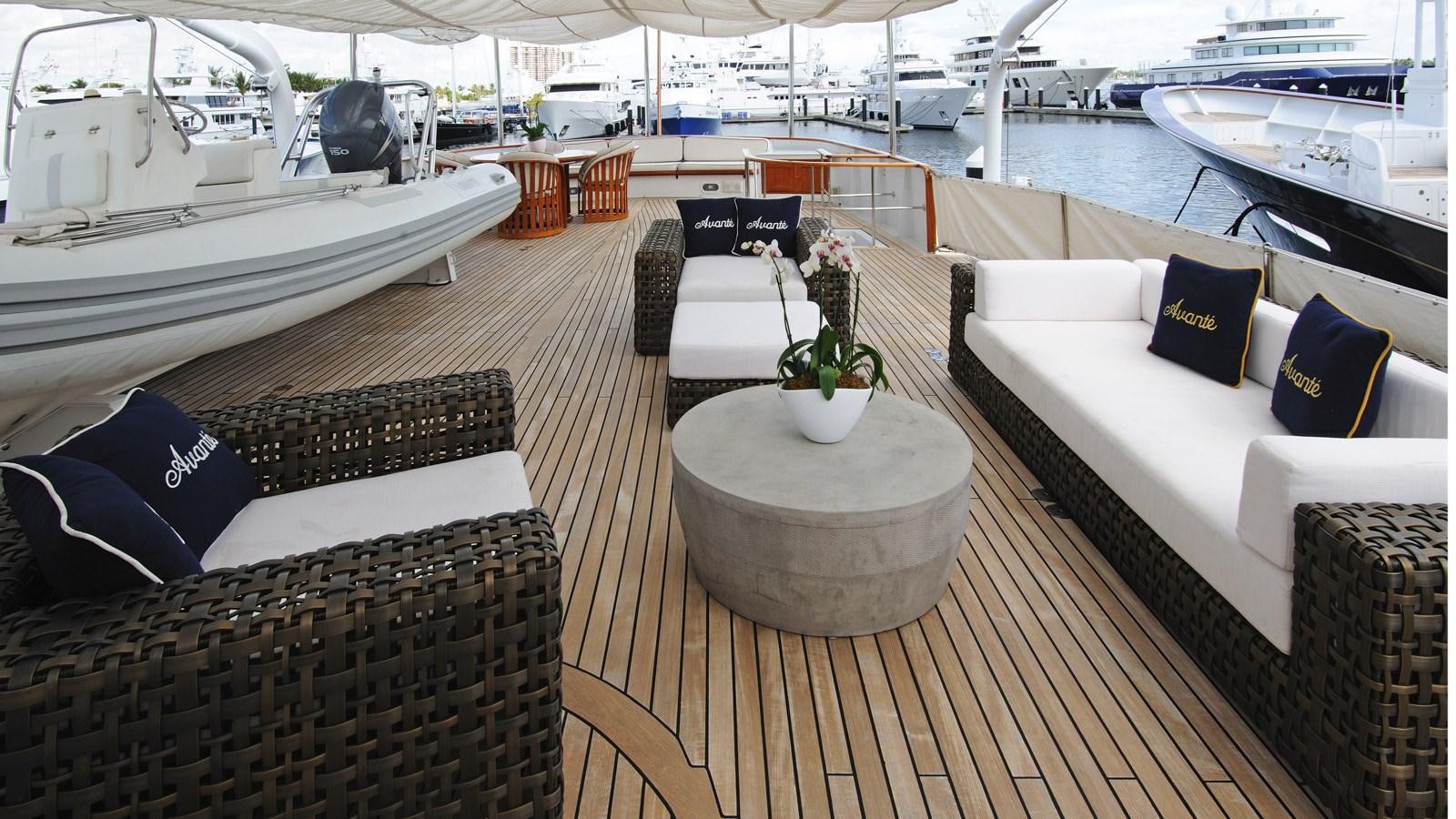 a deck with a large white boat and a large white sofa and a large white boat in the aboard AVANTE V Yacht for Sale