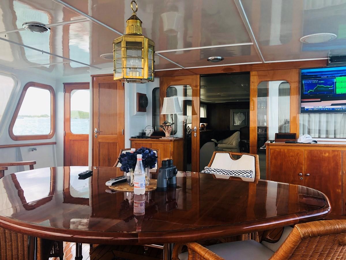 a dining room with a chandelier aboard AVANTE V Yacht for Sale