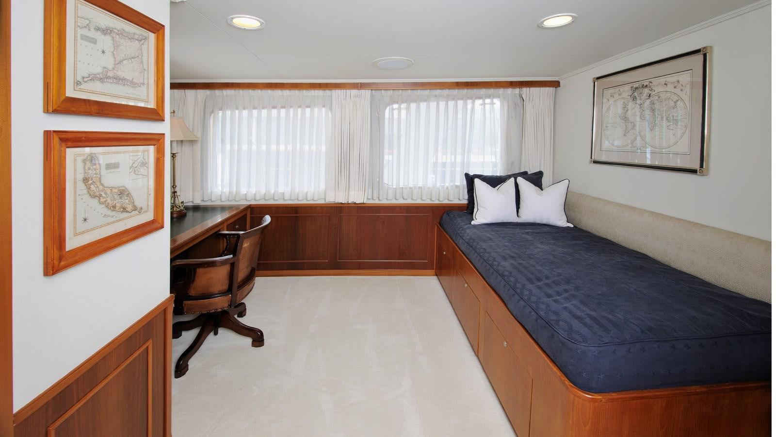 a bedroom with a bed and a chair aboard AVANTE V Yacht for Sale