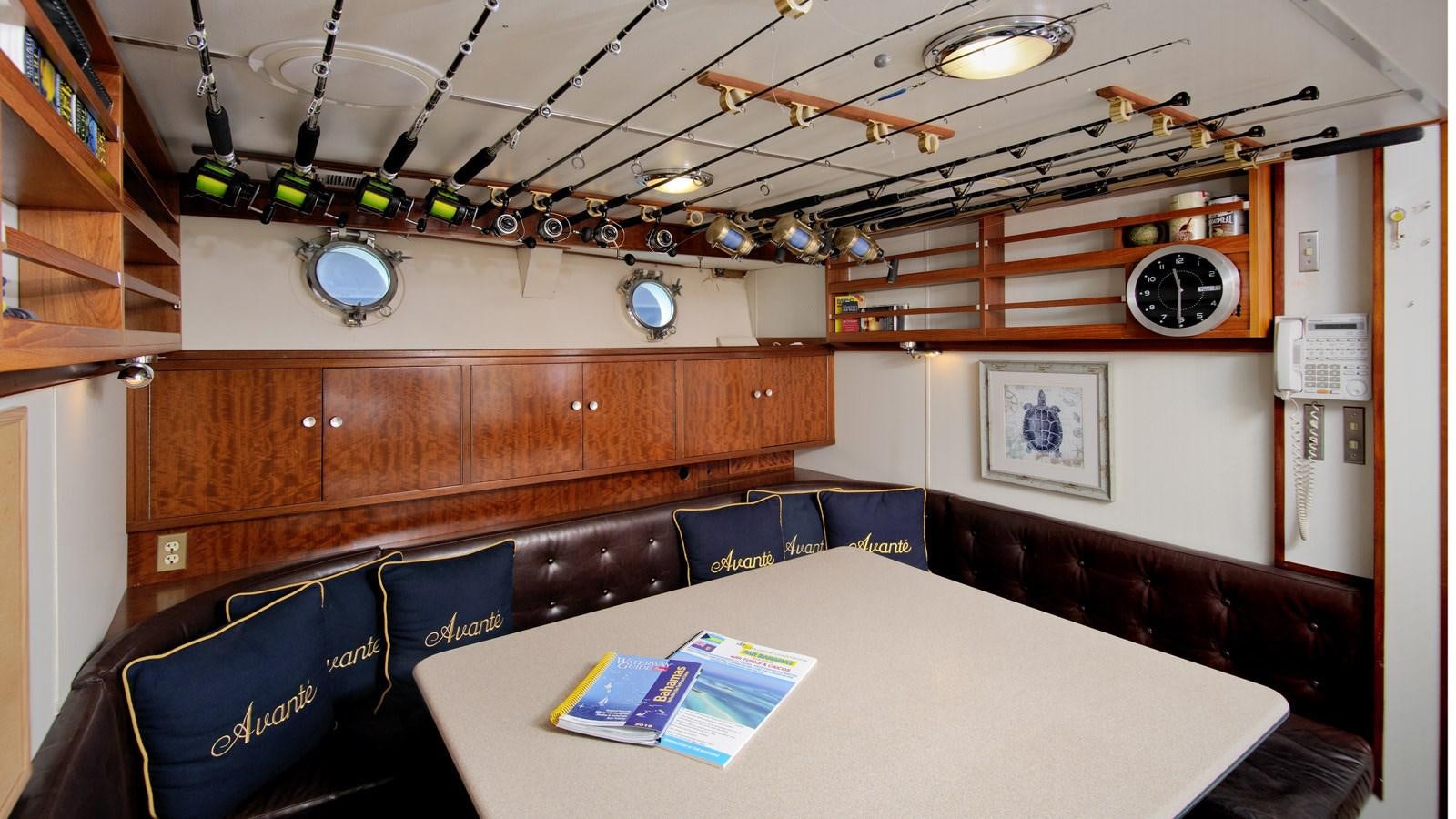 a room with a table and chairs aboard AVANTE V Yacht for Sale