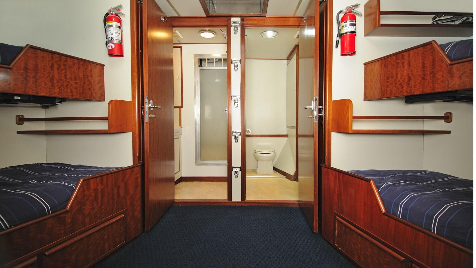 a room with a bed and a door aboard AVANTE V Yacht for Sale