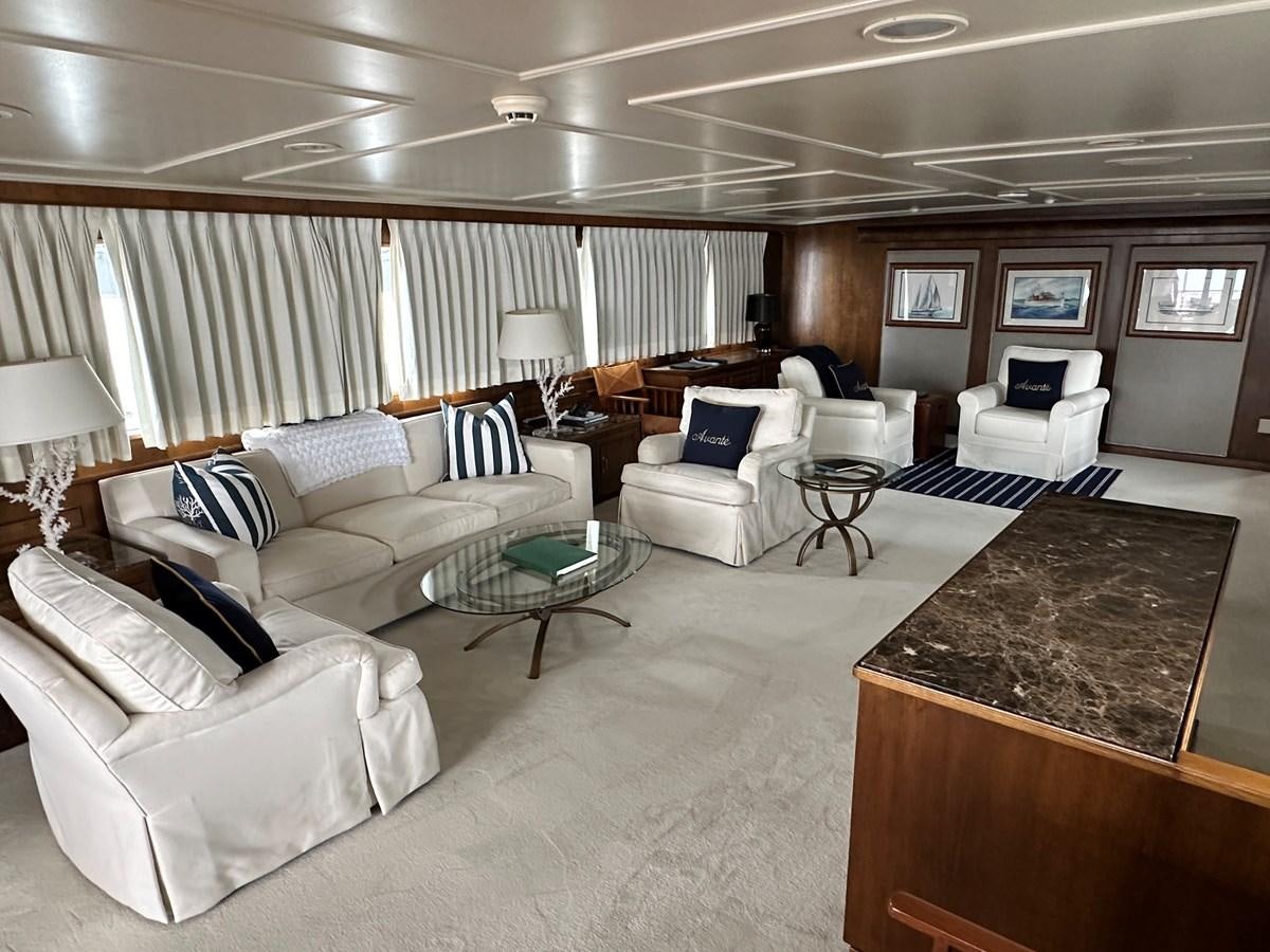 a living room with white furniture aboard AVANTE V Yacht for Sale
