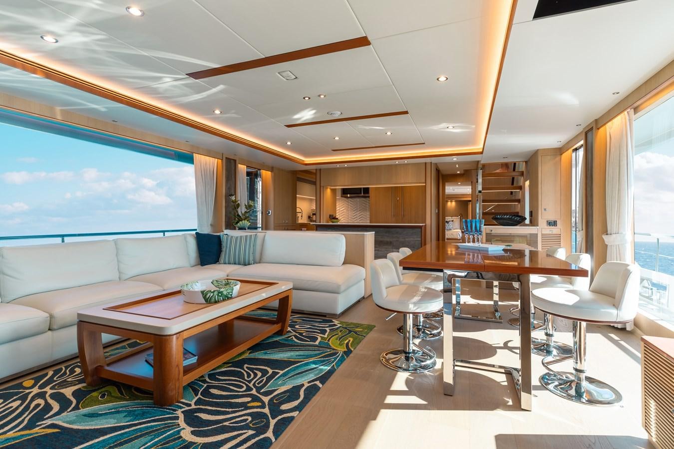 a living room with a table and couches aboard ONE MORE TIME Yacht for Sale