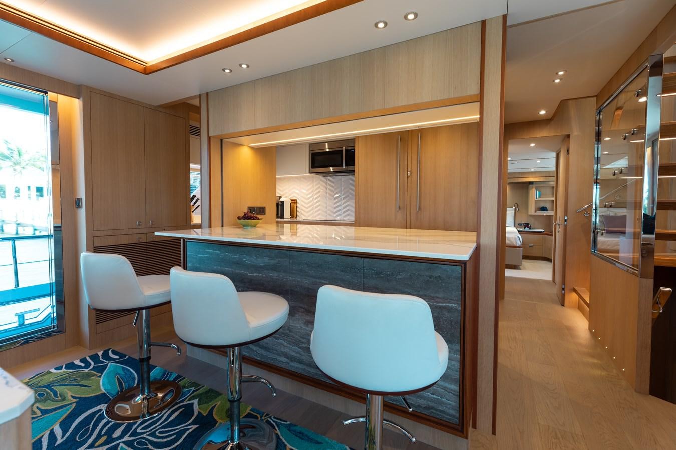 a kitchen with a bar and stools aboard ONE MORE TIME Yacht for Sale