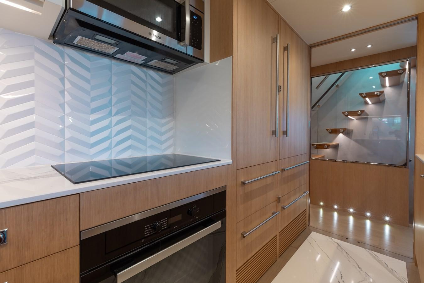 a kitchen with a glass wall aboard ONE MORE TIME Yacht for Sale