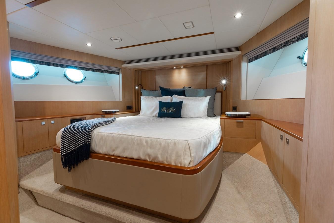 a room with a bed and a window aboard ONE MORE TIME Yacht for Sale