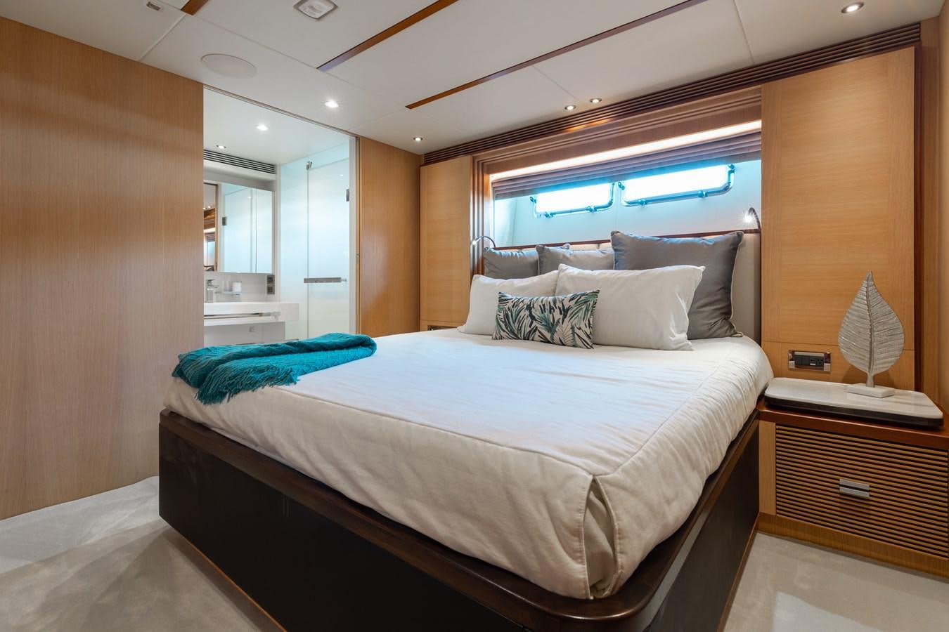a bed with a white bed spread aboard ONE MORE TIME Yacht for Sale