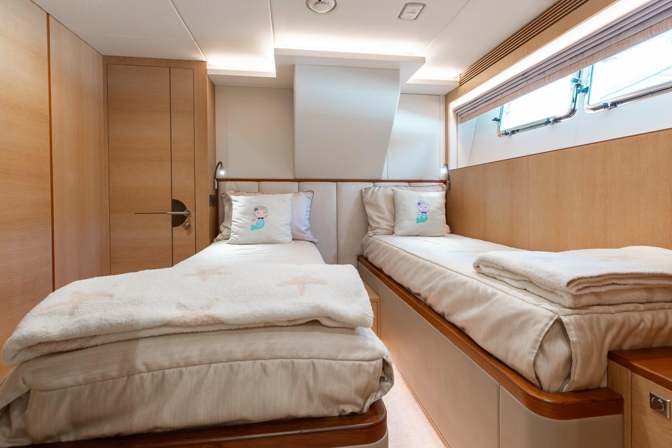 a room with beds and a closet aboard ONE MORE TIME Yacht for Sale