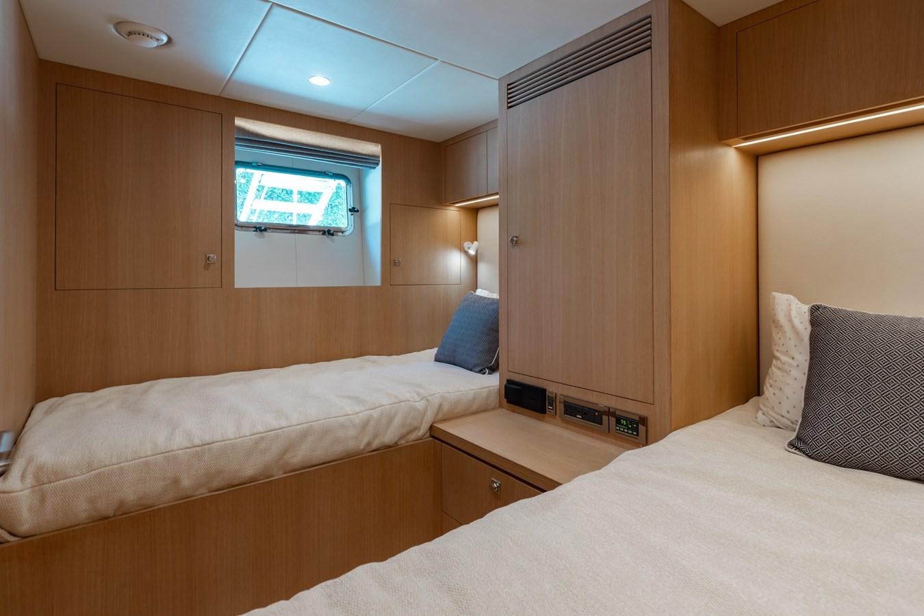 a room with a bed and a window aboard ONE MORE TIME Yacht for Sale