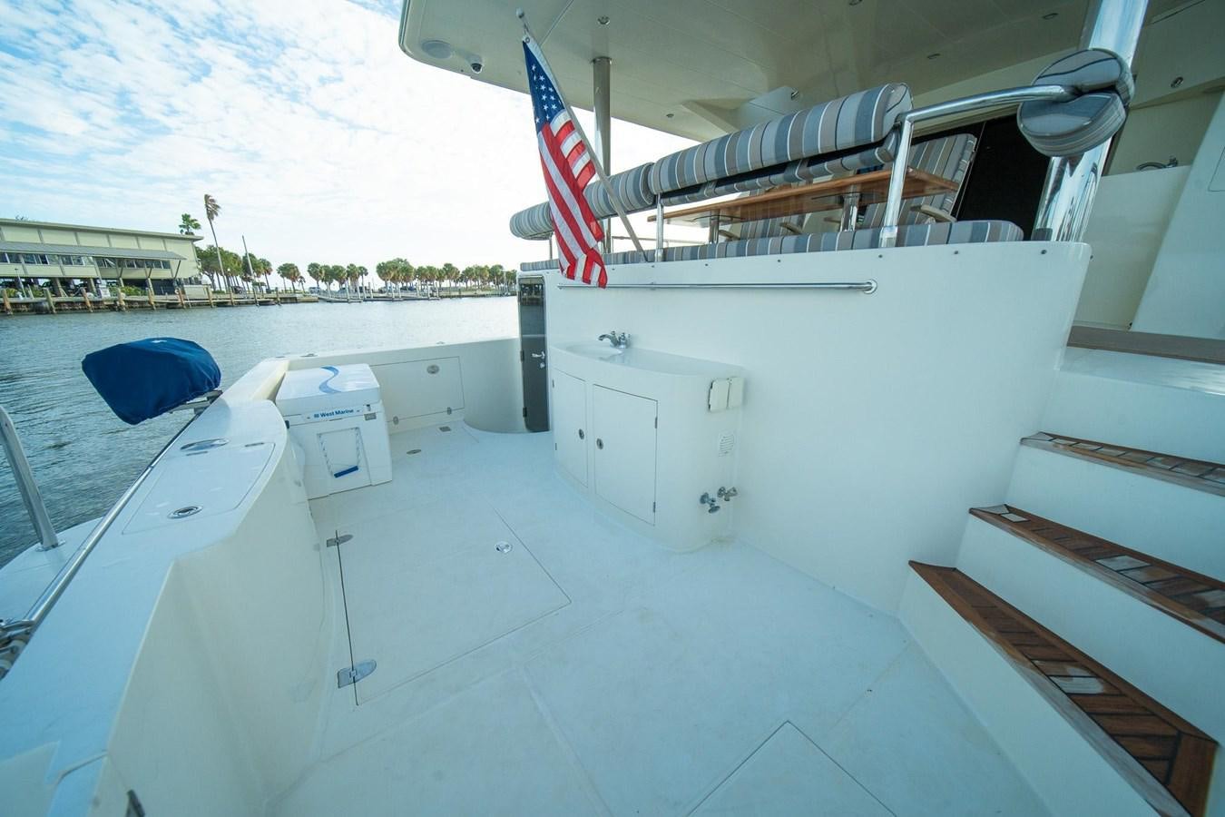 a white building with a flag on it aboard PRETTY PENNY Yacht for Sale