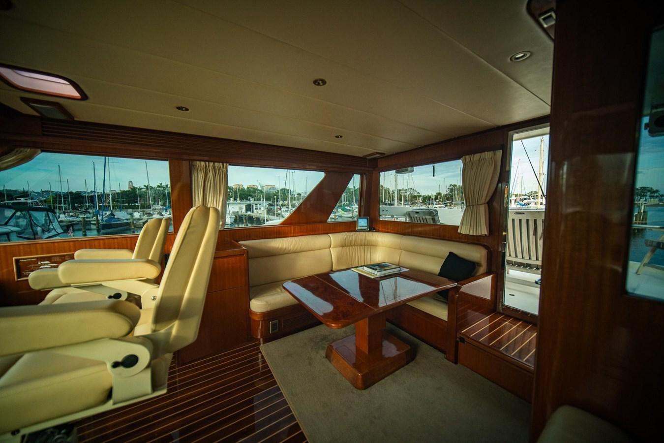 a room with a table and chairs aboard PRETTY PENNY Yacht for Sale