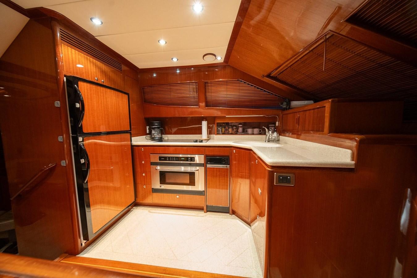 a kitchen with wooden cabinets aboard PRETTY PENNY Yacht for Sale