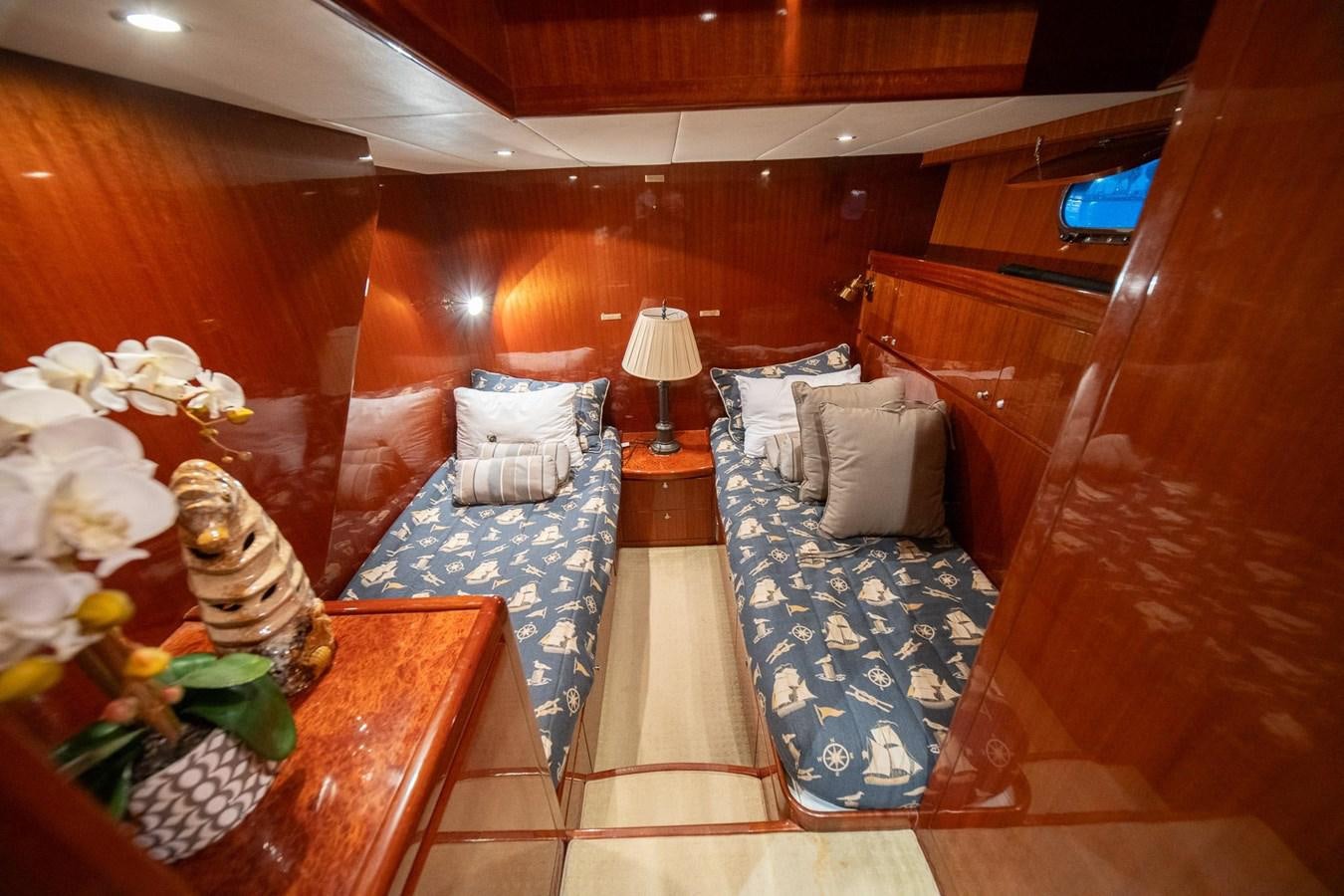 a room with beds and a table aboard PRETTY PENNY Yacht for Sale