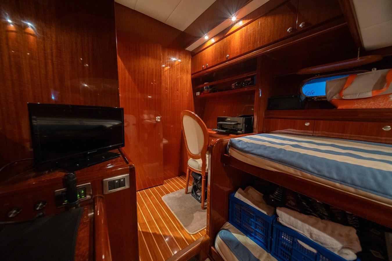 a room with a tv and bunk beds aboard PRETTY PENNY Yacht for Sale