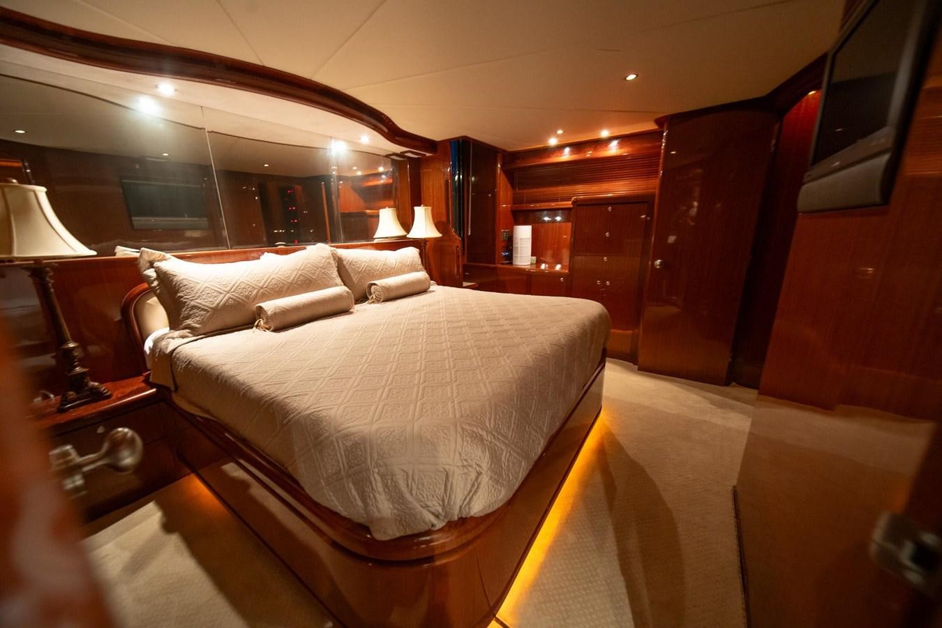 a room with a bed and a chair aboard PRETTY PENNY Yacht for Sale